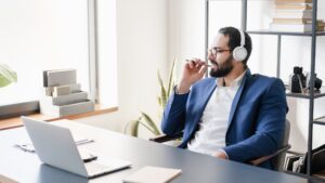 Relaxed Arabian businessman manager CEO boss listening to webinar, online meeting